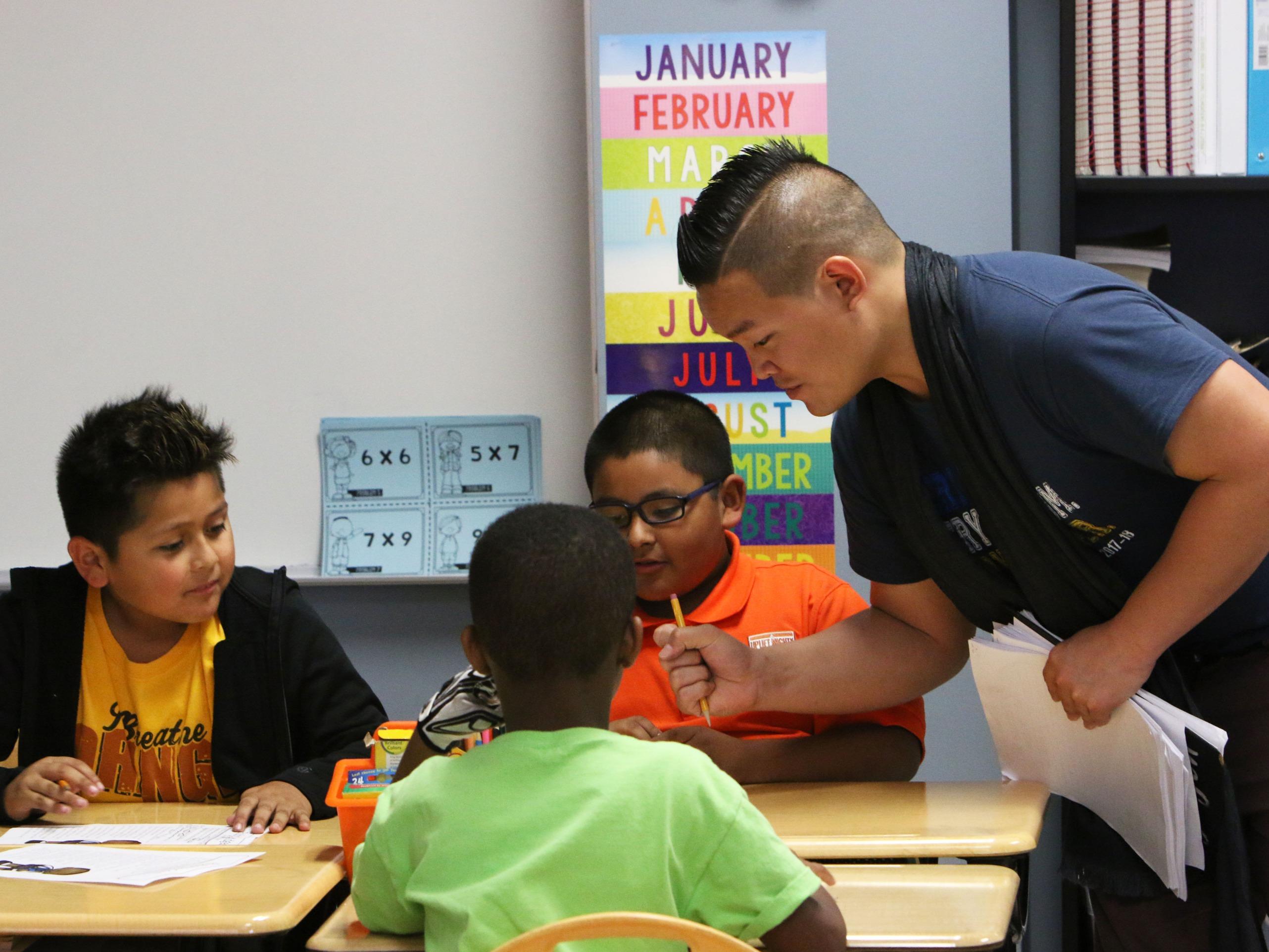 Houston area male teacher of color with students.